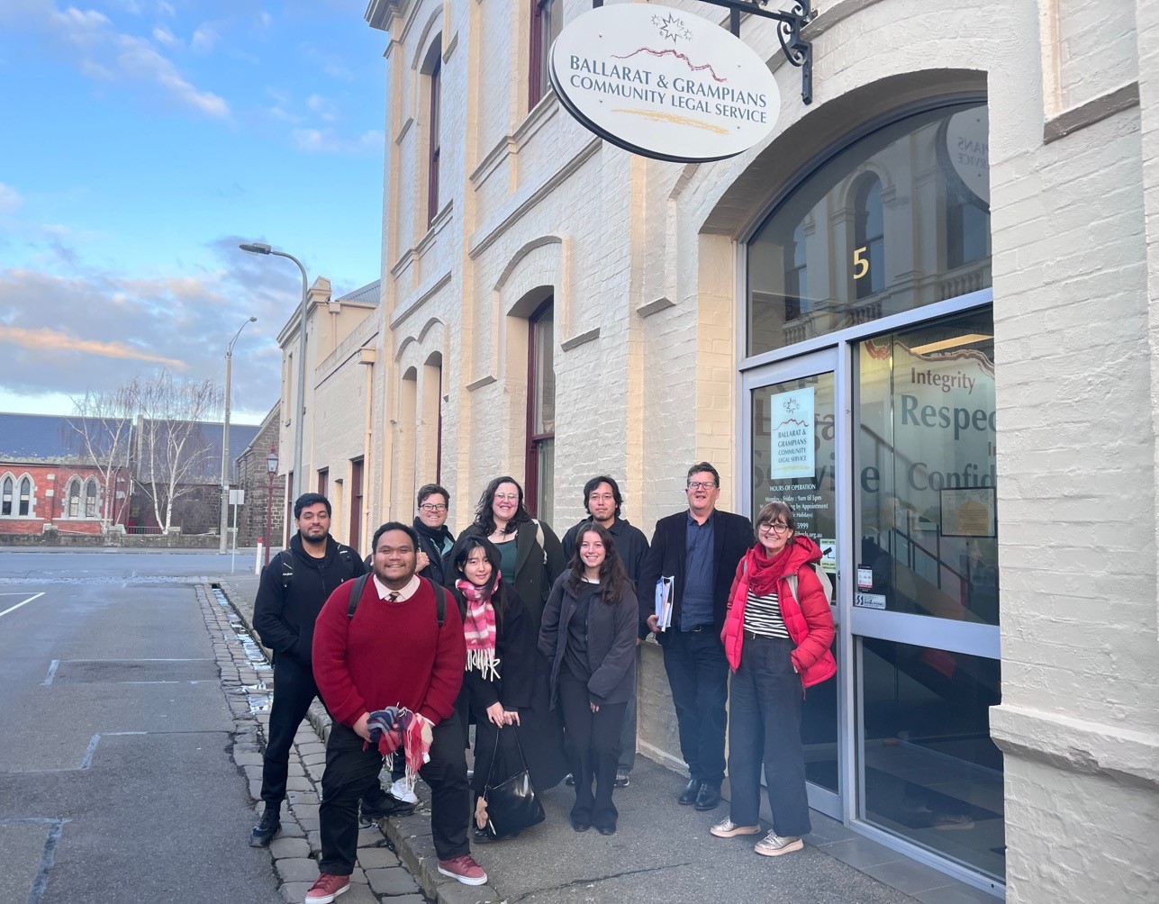 Group of people standing outside a community legal service building