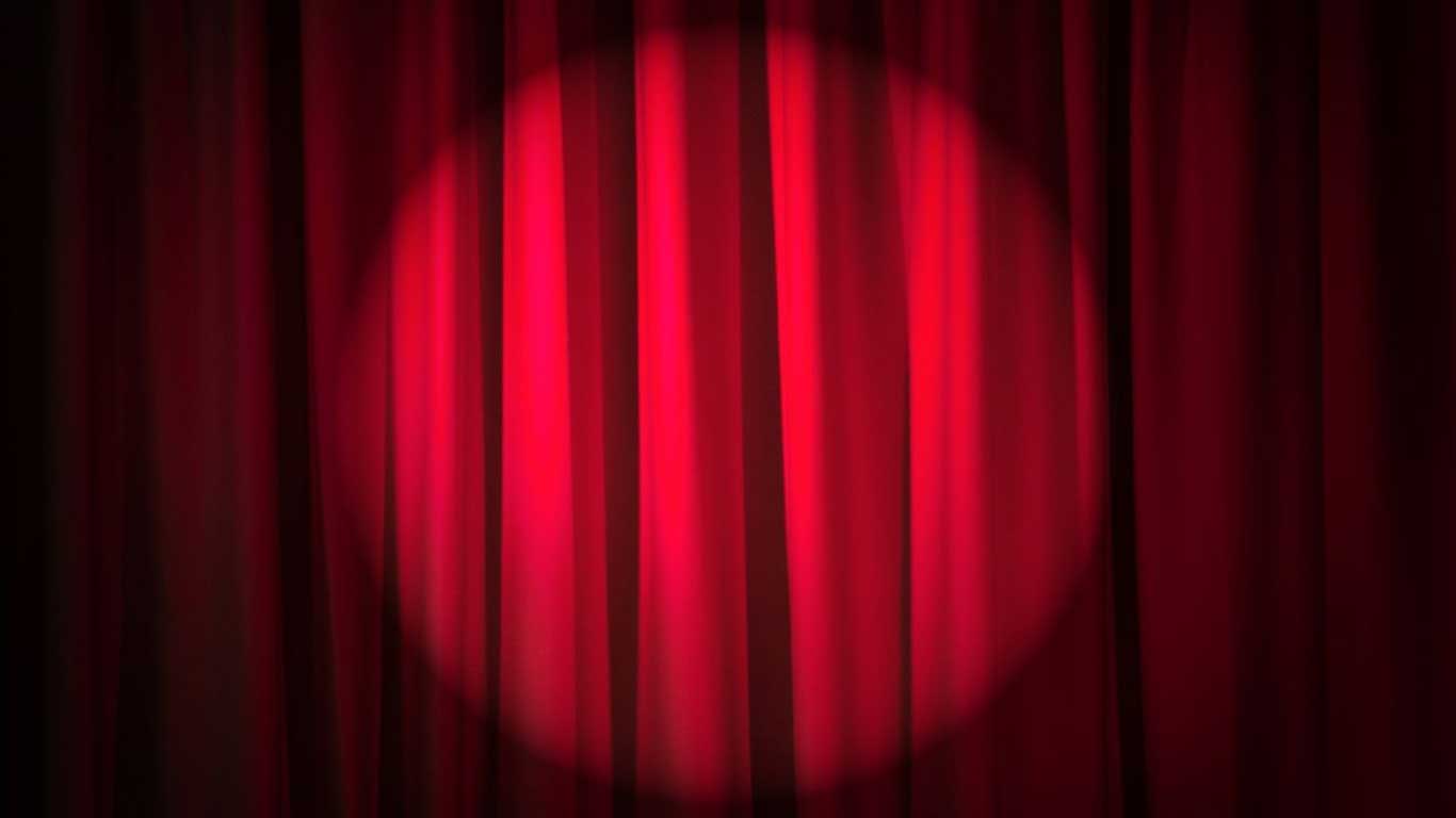 Red velvet curtains with a spotlight in the middle.