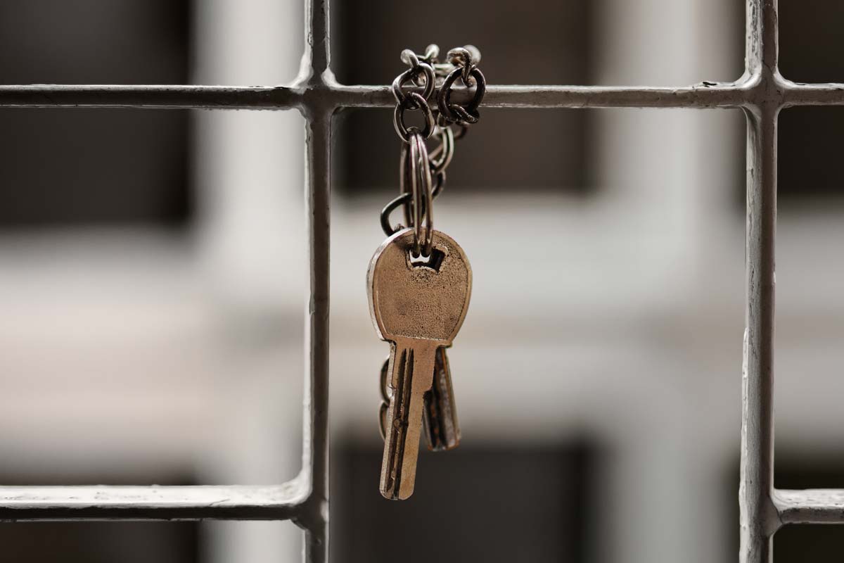 A photo of some keys hanging on a fence