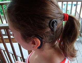 Photo of child with cochlear implant