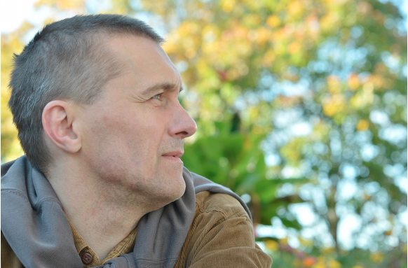 Profile image of a man looking into the distance.