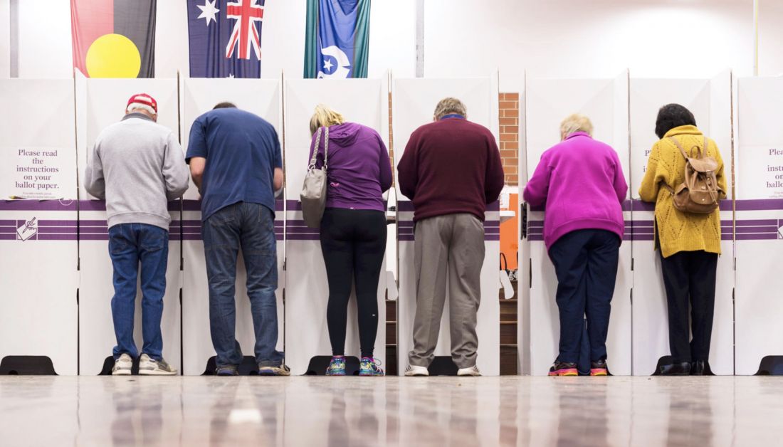 Australian voters stand at voting booth