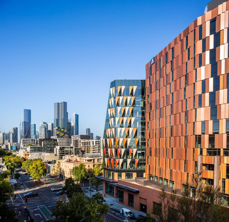 The Melbourne Connect building with the city of Melbourne and blue sky in the background