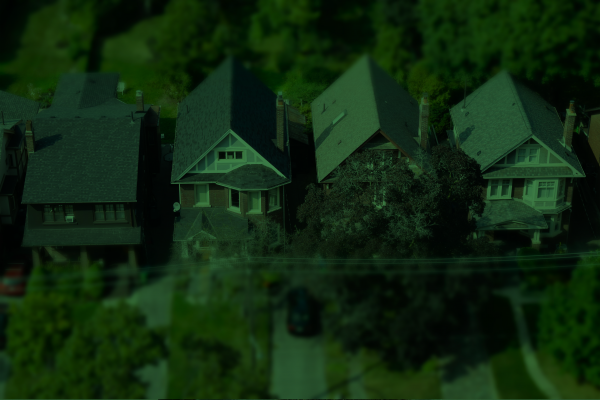 A tinted image of four houses in a neighbourhood.