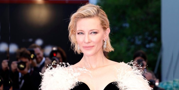 Cate Blanchett on the red carpet with photographers in the background capturing the moment.