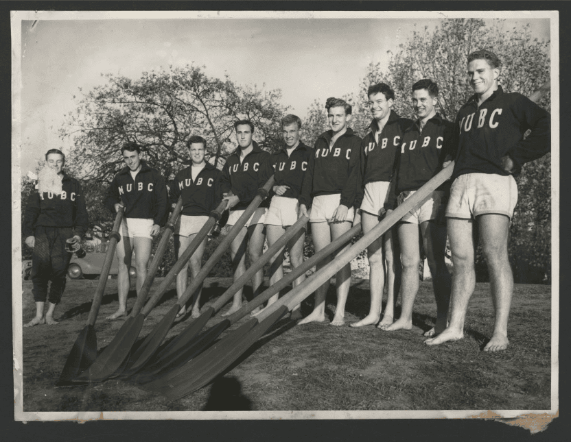 Melbourne University 1st rowing crew on the bank of the Yarra River, 1957. 'Taffy' Jones fourth from right. MM 003179 - Courtesy of Trinity College Archives