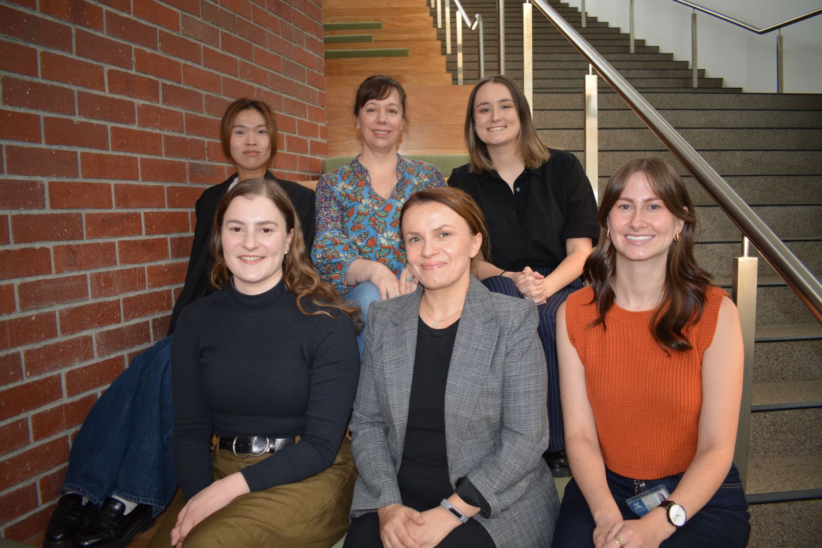 Six people sitting on a staircase