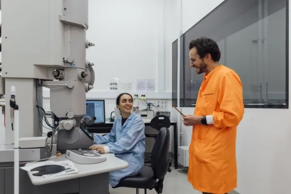 Two scientists working at a large imaging machine