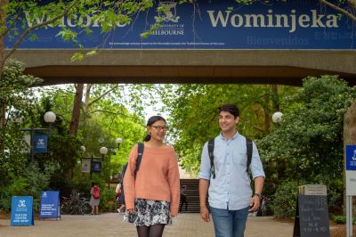 Image of students under the Welcome sign at the University of Melbourne Parkville campus