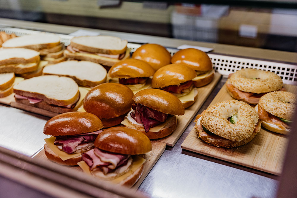 Bagels, breakfast burgers and sandwiches in a display case