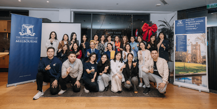 Vietnamese alumni posing for group photo at event.