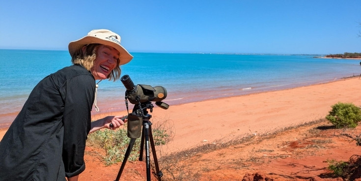 Kate watching birds through a camera in the Outback