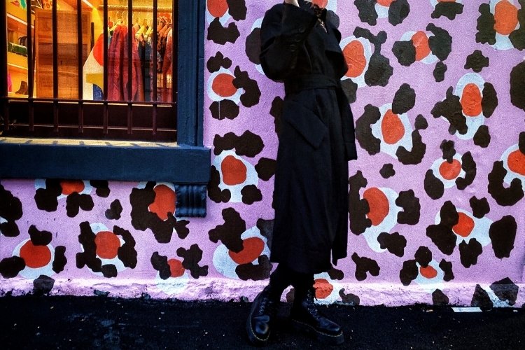 Zihui posing against a leopard print wall