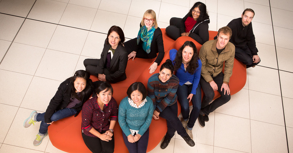 Ten people sitting on a large couch
