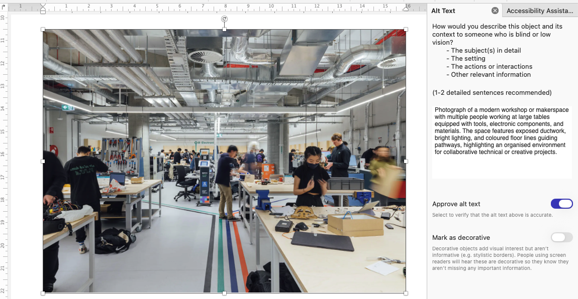 The Alt Text pane in Microsoft Word Photograph of a modern workshop or makerspace with multiple people working at large tables equipped with tools, electronic components, and materials. Space features exposed ductwork, bright lighting, coloured floor lines guiding pathways, and an organised environment for collaborative technical or creative projects.