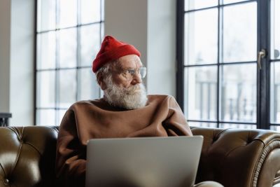 Image of an elderly man with a laptop.