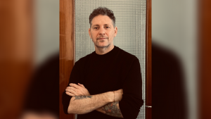 Portrait image of Brook Andrew in front of blurred background