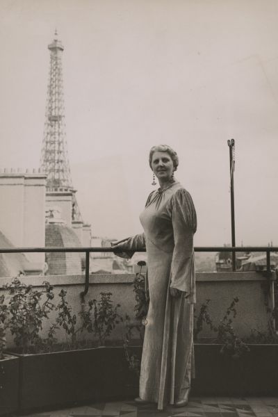 Louise Dyer on a balcony overlooking the Eiffel Tower in Paris.