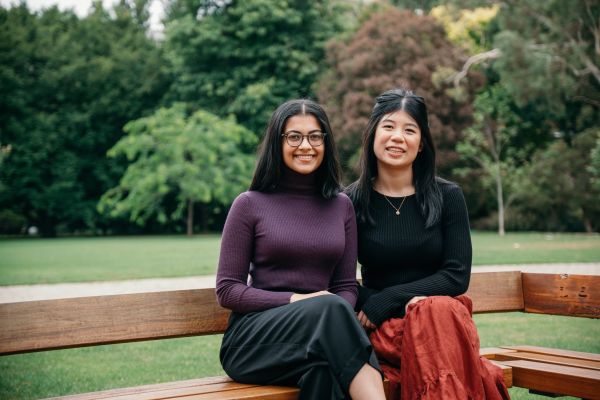 Two students sitting in front of South Lawn