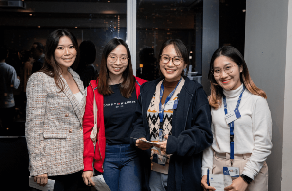 A group of four Welcome to Melbourne participants smiling to camera.