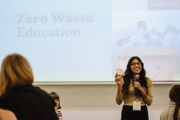Staff member in front of big screen conducting Zero Waste event