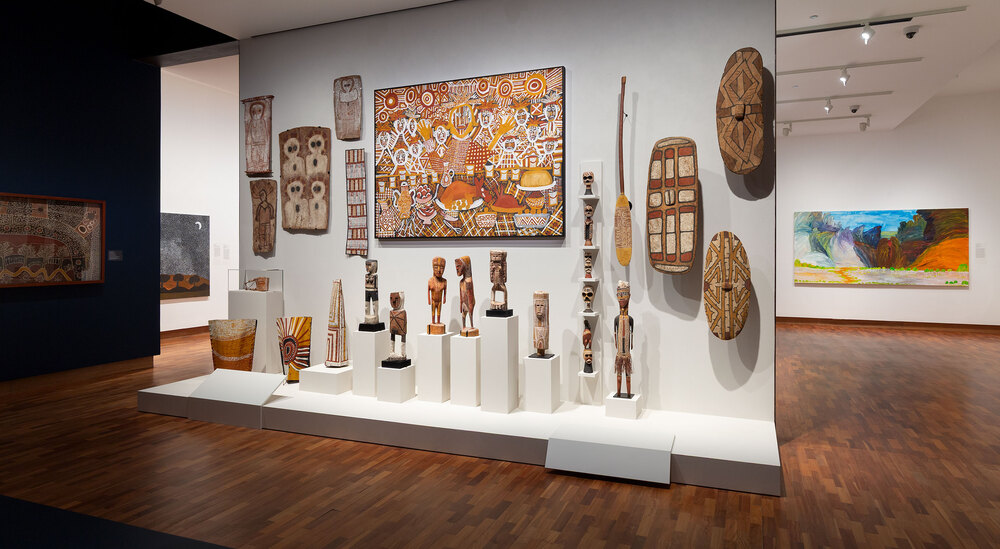 A gallery wall showcasing various pieces of art in different styles and colours.