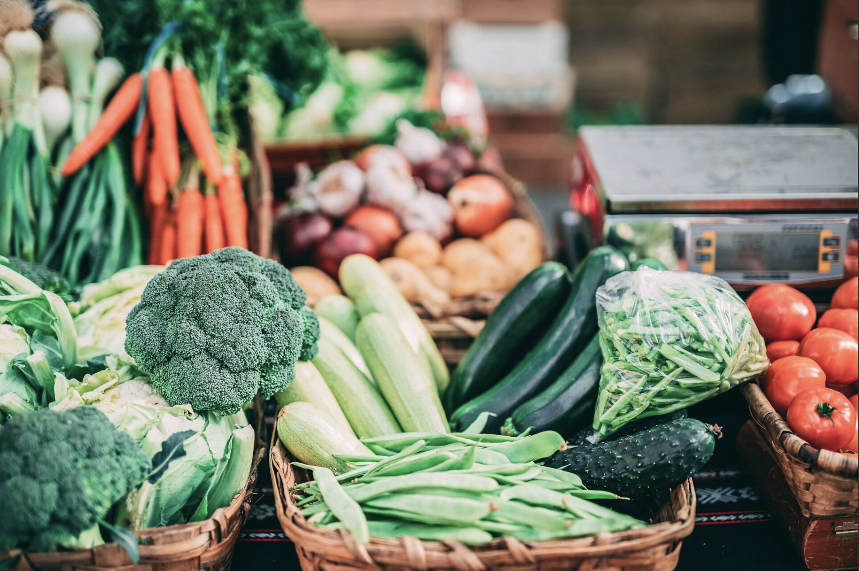 Baskets of fresh vegetables at a market stall.