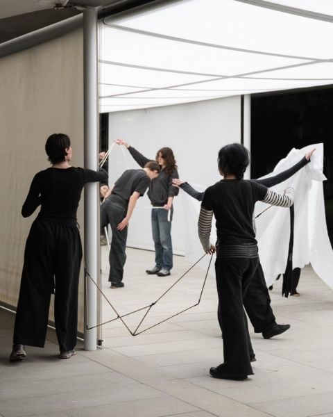 Students performing with movement and materials