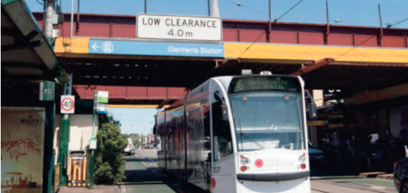 Tram passing under a low bridge