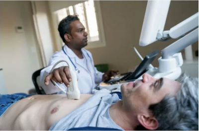 Person laying down having an ultrasound on their chest 