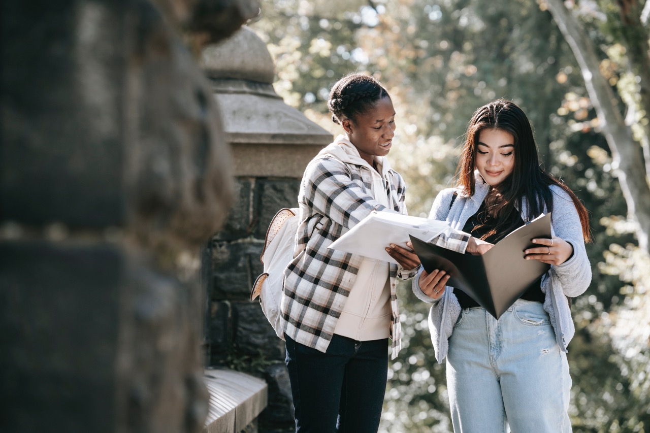 Two students, looking at paperwork