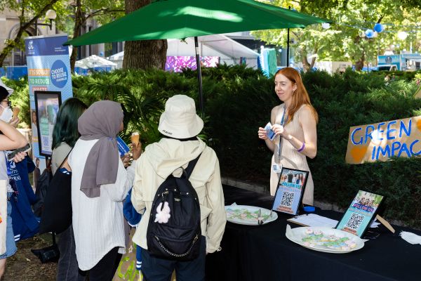Students at Green Impact stall talking to a staff member.