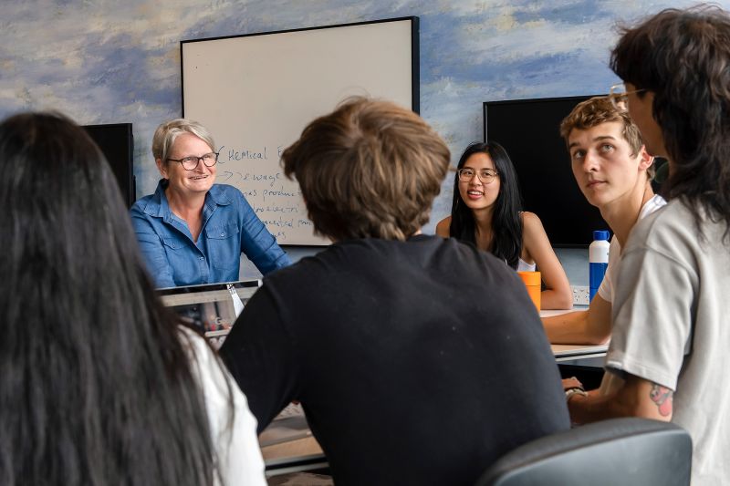 A teacher in discussion with a group of students