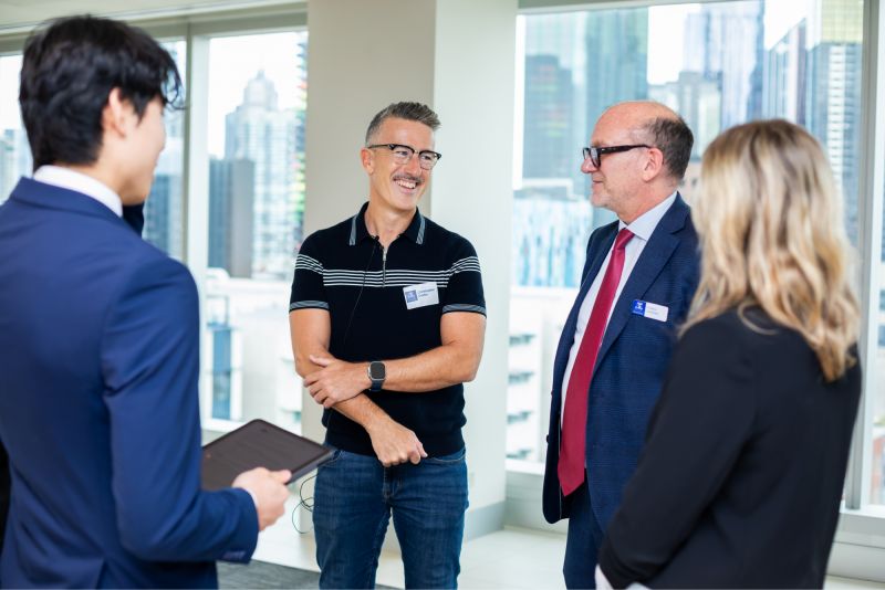 Chris Crellin and Deputy Dean, Faculty Business and Economics Professor Paul Jensen with talking with University students at a Fireside Chat in October 2024.