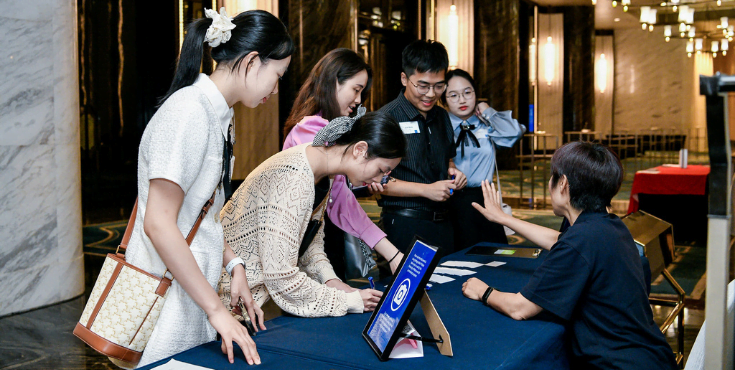 Alumni smiling and mingling at a Hong Kong Alumni Association event.