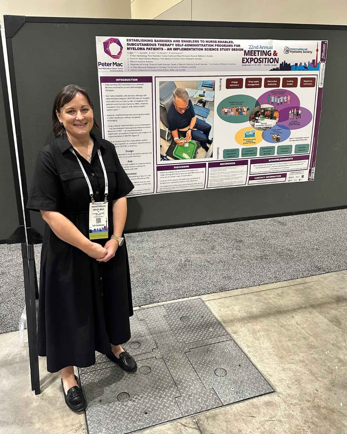 Hayley standing next to her presentation at the Myeloma Society Meeting