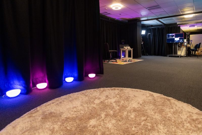 An empty but well-lit immersive media studio.