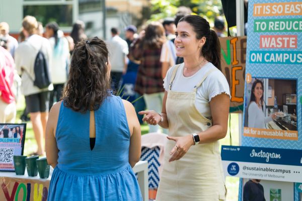 Two women speaking at sustainability stall