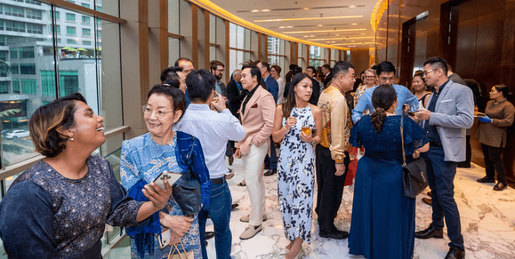 A large group of alumni mingling at a Malaysia Alumni Association event.