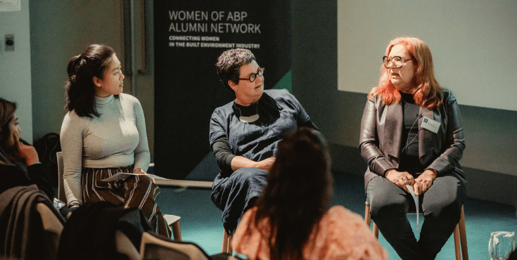 Three women speaking on a panel for a Women of ABP Alumni Network event.