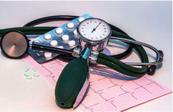 Image of a stethescope some medicines and other medical paraphernalia.