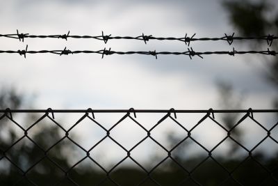 Black and white barbed wire fence 