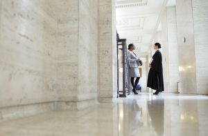 Judge and lawyer standing in a corridor