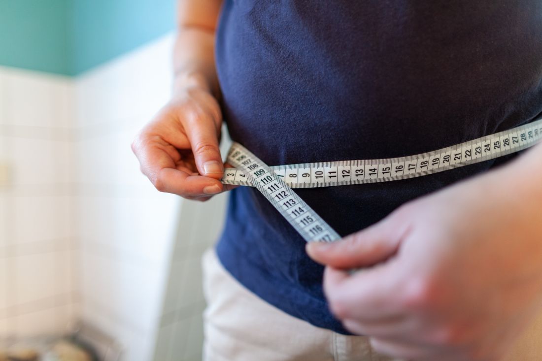 Overweight male with a measuring tape 