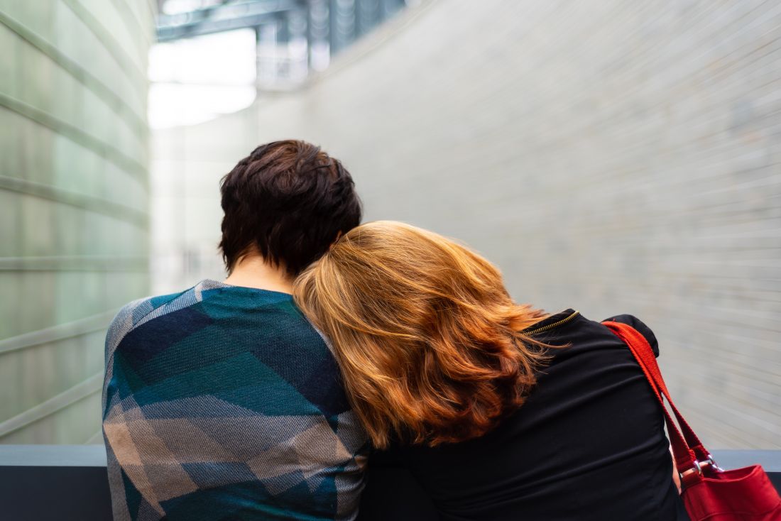 Women leaning on each other