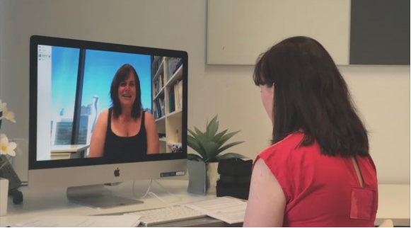 A study participant talks with a therapist in an online consultation for chronic knee pain.
