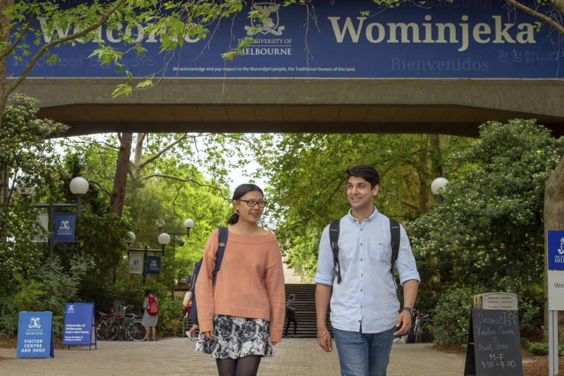 Two students walk on the University of Melbourne campus