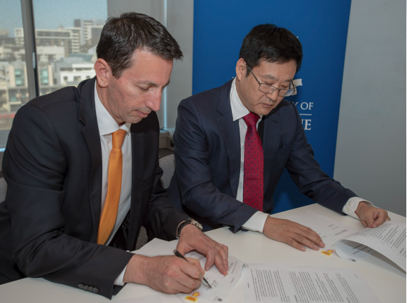 Image of University of Melbourne and First Bio-Pharma officials signing the MOU together.