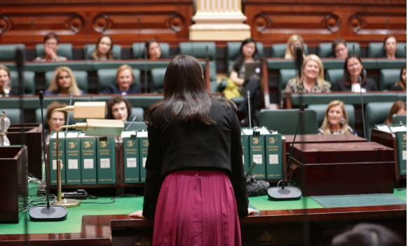 Image of a female politician addressing the parliament.