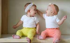 Twin babies looking at each other